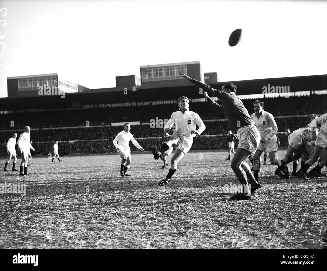 England's Simon Clarke (c) kicks for touch as Wales' Alun Pask (r