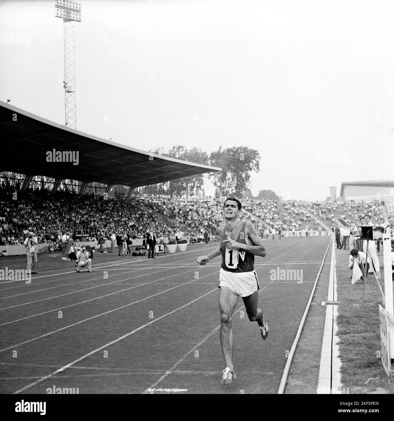 Ron Clarke crosses the line to win the 2 miles in a new world record