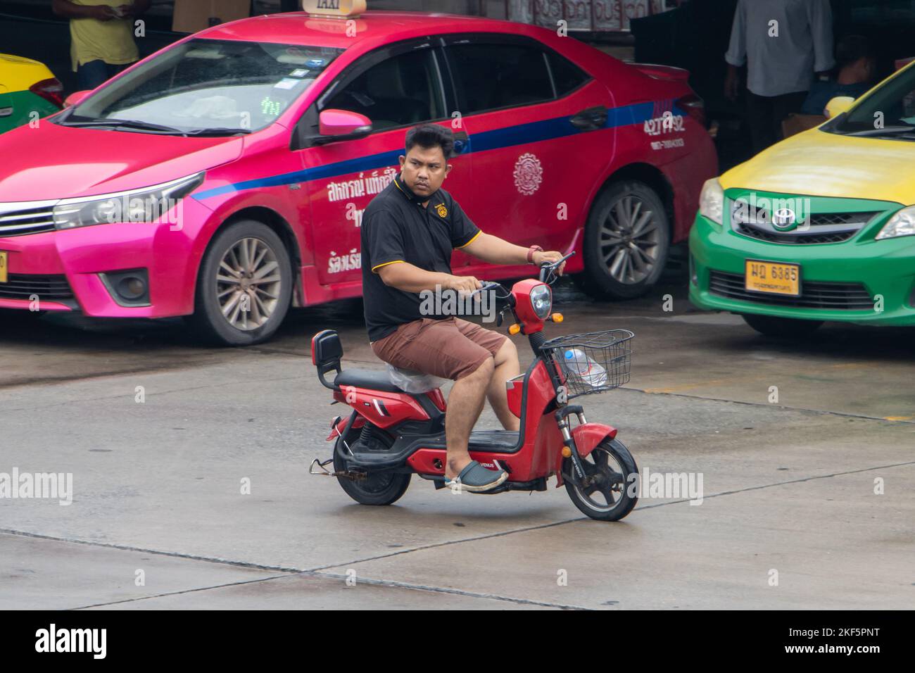 SAMUT PRAKAN, THAILAND, SEP 26 2022, A man rides an electric scooter Stock Photo