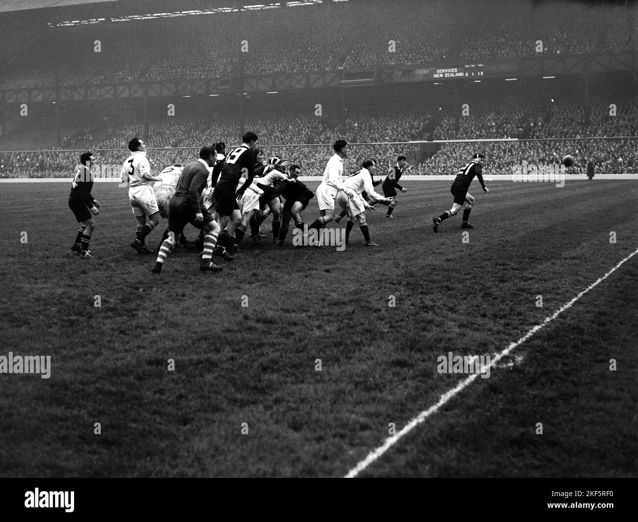 New Zealand's Bill Clark (r) chases the ball as it bounces loose from a ...
