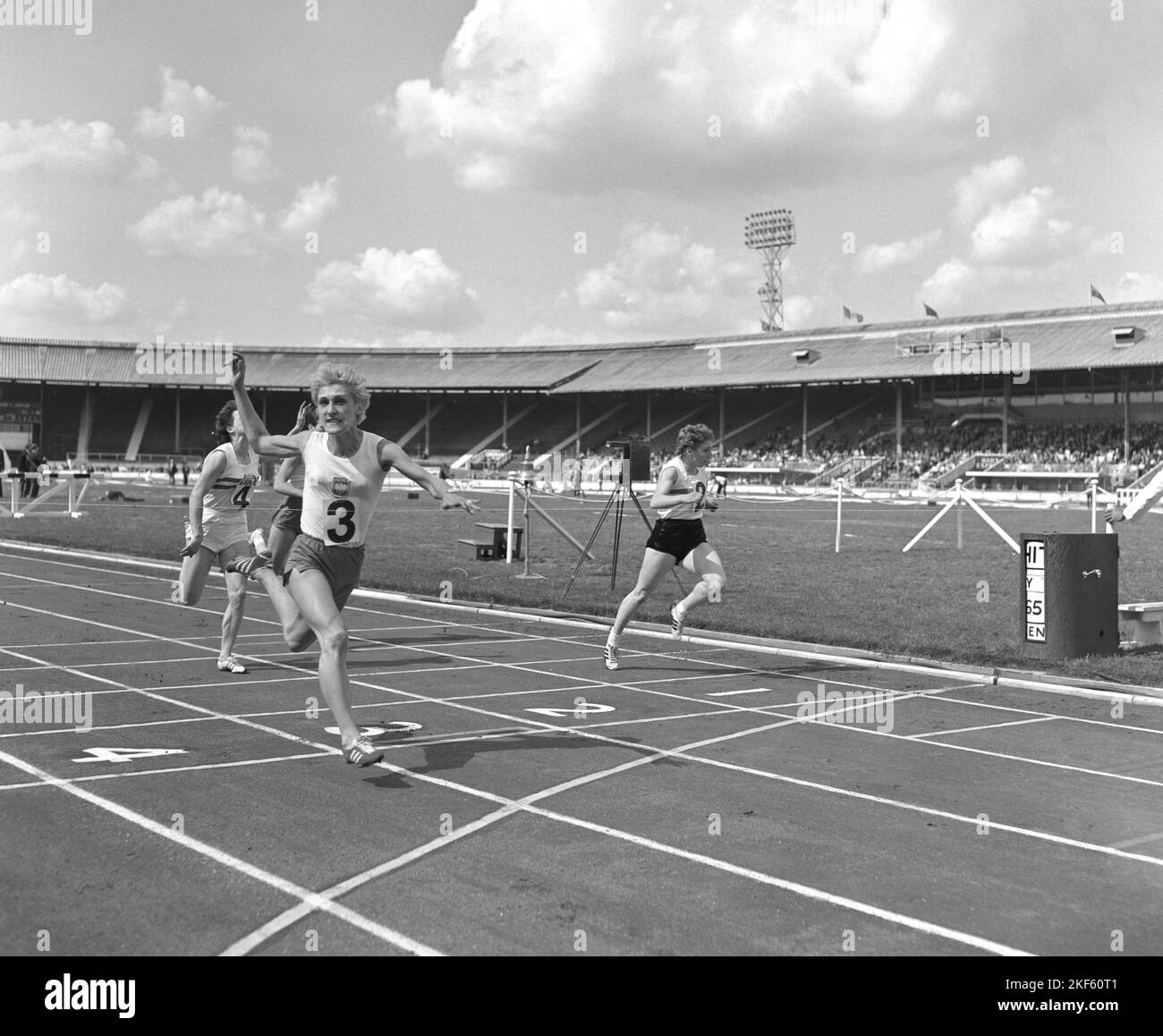 Poland's Ewa Klobukowska (3) wins from Great Britain's J. Hall (r) and