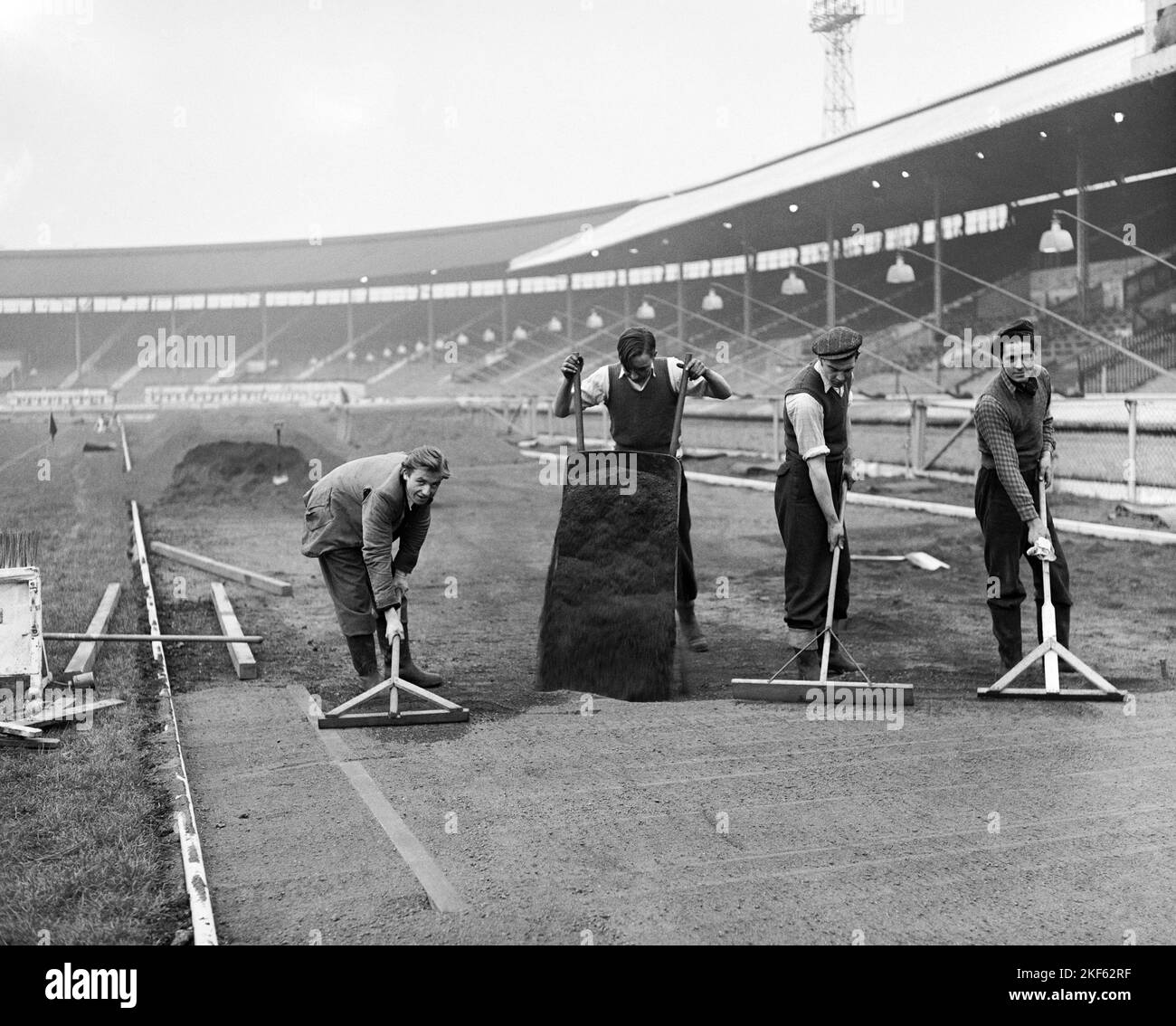 The top dressing is being laid and raked prior to rolling Stock Photo