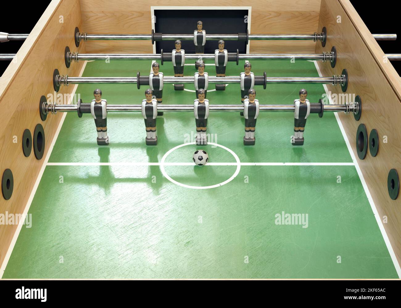 One side of a vintage foosball or table football table with worn metal