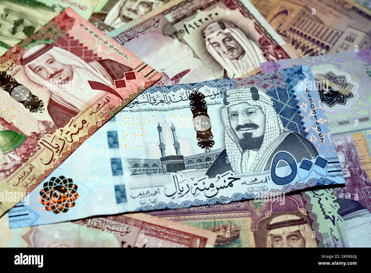 Saudi Arabia riyals money banknotes collection of different times and values feature portraits of Al Saud kings of Saudi Arabia, selective focus of Sa Stock Photo