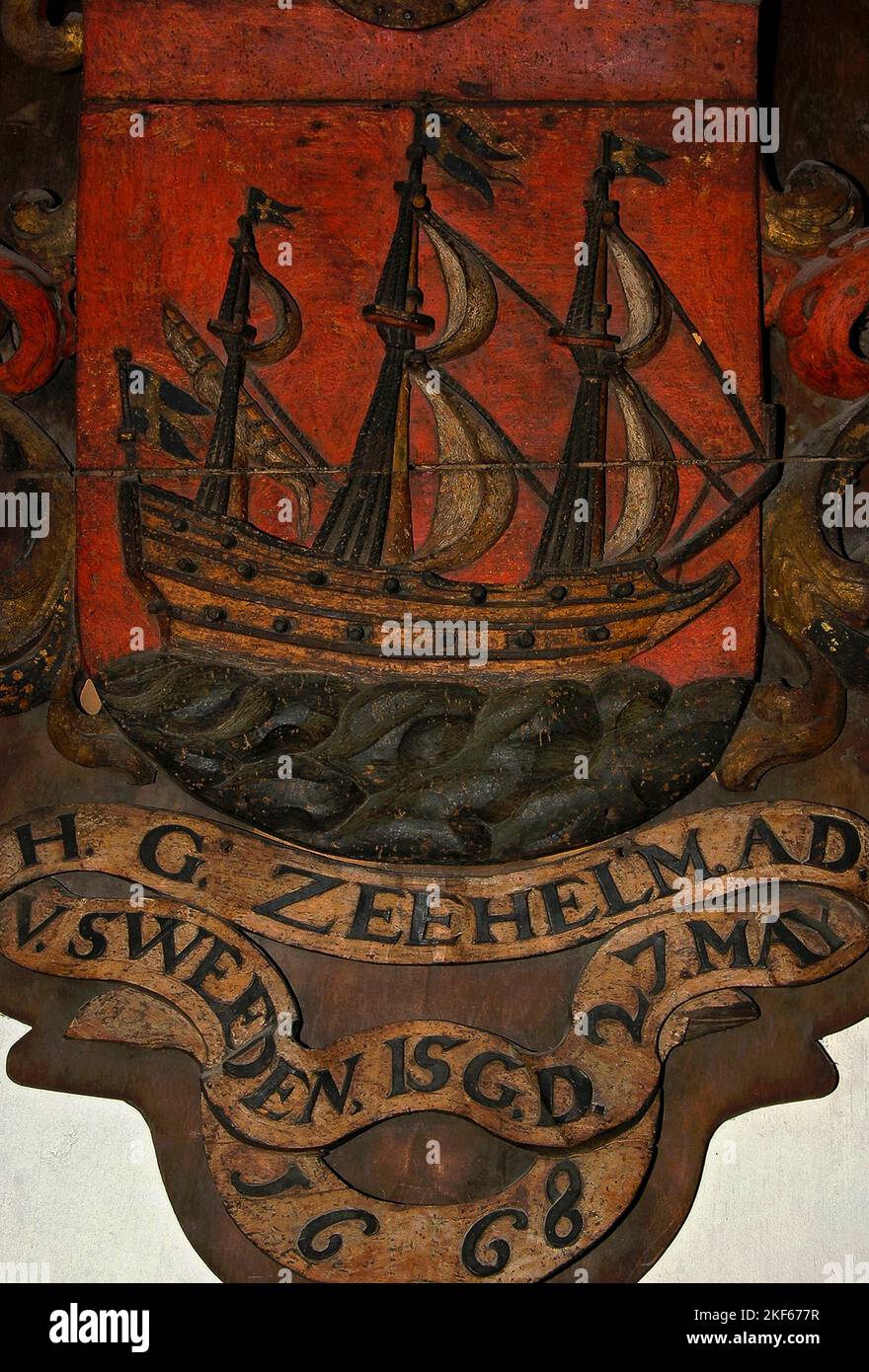 The Swedish flag flies from the masts and stern of this warship, painted on wood, marking the tomb of Dutch admiral Hendrick Gerritsz Zeehelm (died 1668), in the Oude Kerk (Old Church) in Ouderkerksplein, Amsterdam, North Holland, Netherlands.  Admiral Zeehelm served the Dutch Republic, Sweden and the Dutch colony of New Netherland on the east coast of North America. Stock Photo