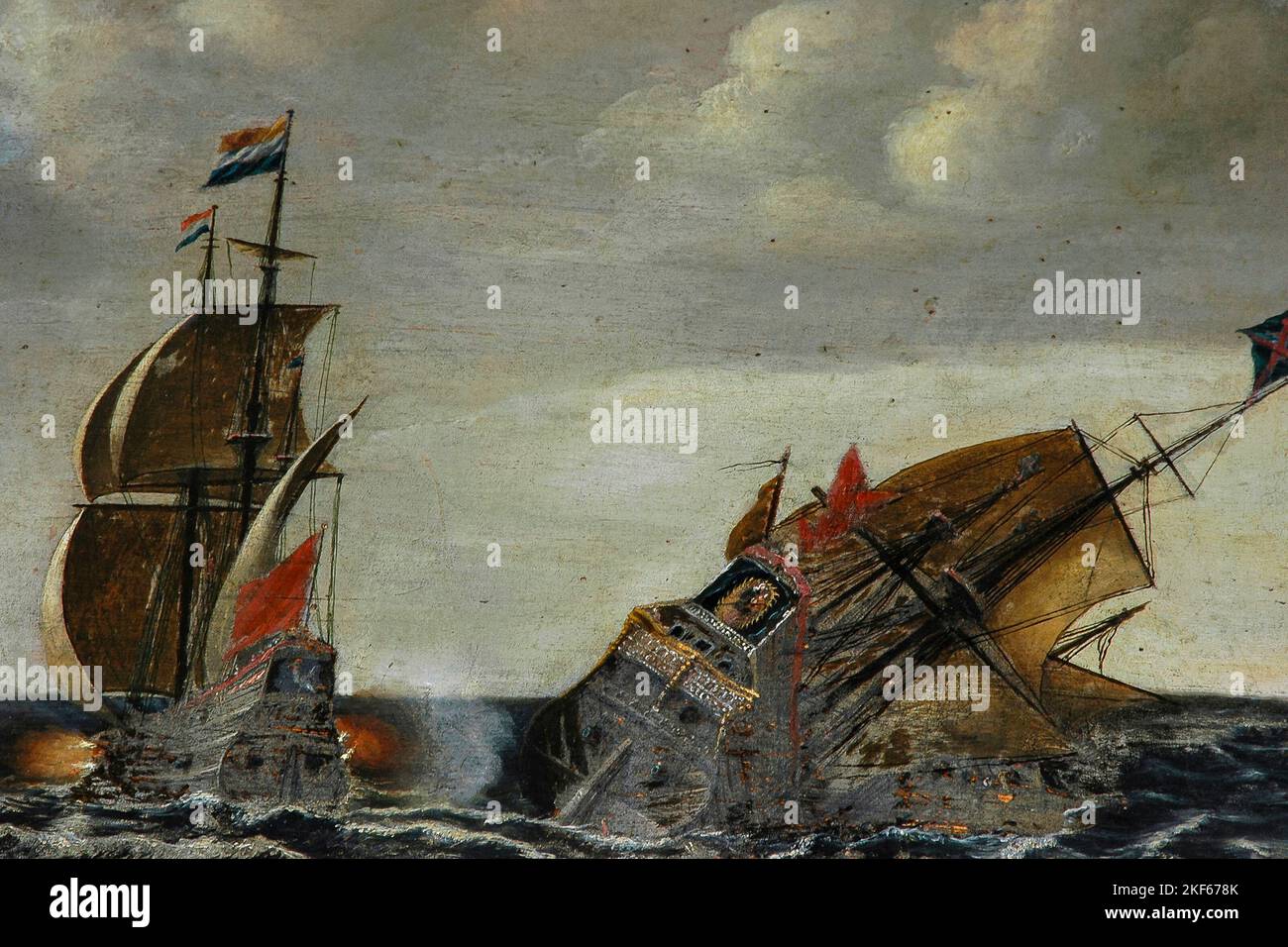 A Dunkirk privateer vessel sinks as a ship captained by Dutch Golden Age naval hero Cornelis Janszoon de Haan (1580-1633), known as Haantje or Rooster, rakes it with cannon fire.  Detail of oil painting on his gilded Baroque monument in the Oude Kerk (Old Church) in Ouderkerksplein, Amsterdam, North Holland, Netherlands. Stock Photo