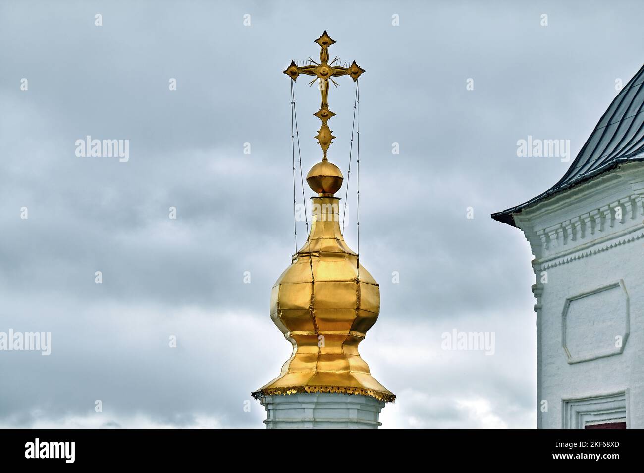 Eastern orthodox crosses on gold domes, cupolas, against blue sky with