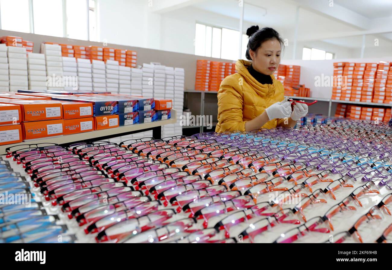 ANQING, CHINA - NOVEMBER 16, 2022 - Employees check a batch of eyewear products exported overseas at Anhui Maisi Optical Technology Development Co LTD Stock Photo