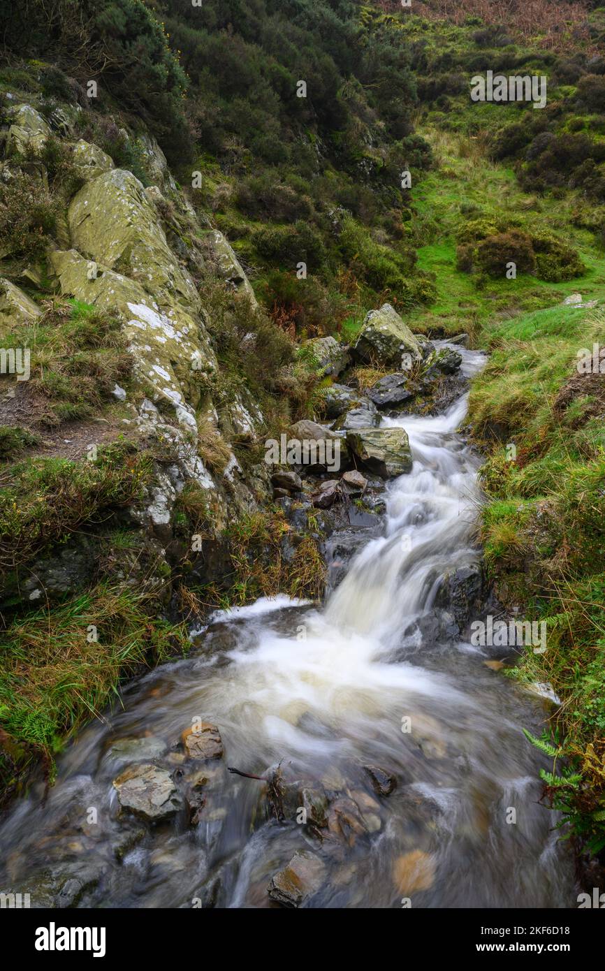 Stream with flowing water over rocks Stock Photo - Alamy