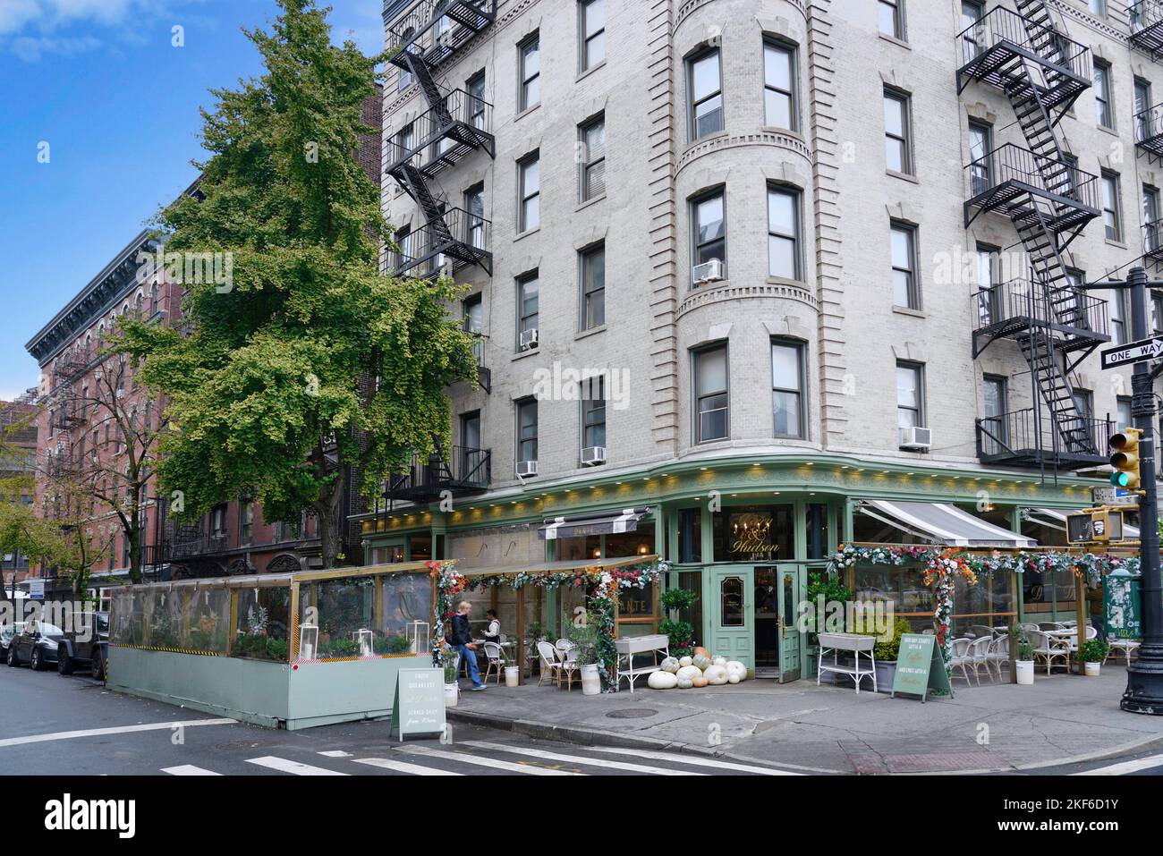 New York, NY - October 2022:  Greenwich Village apartment building with nicely decorated restaurant with outdoor seating Stock Photo