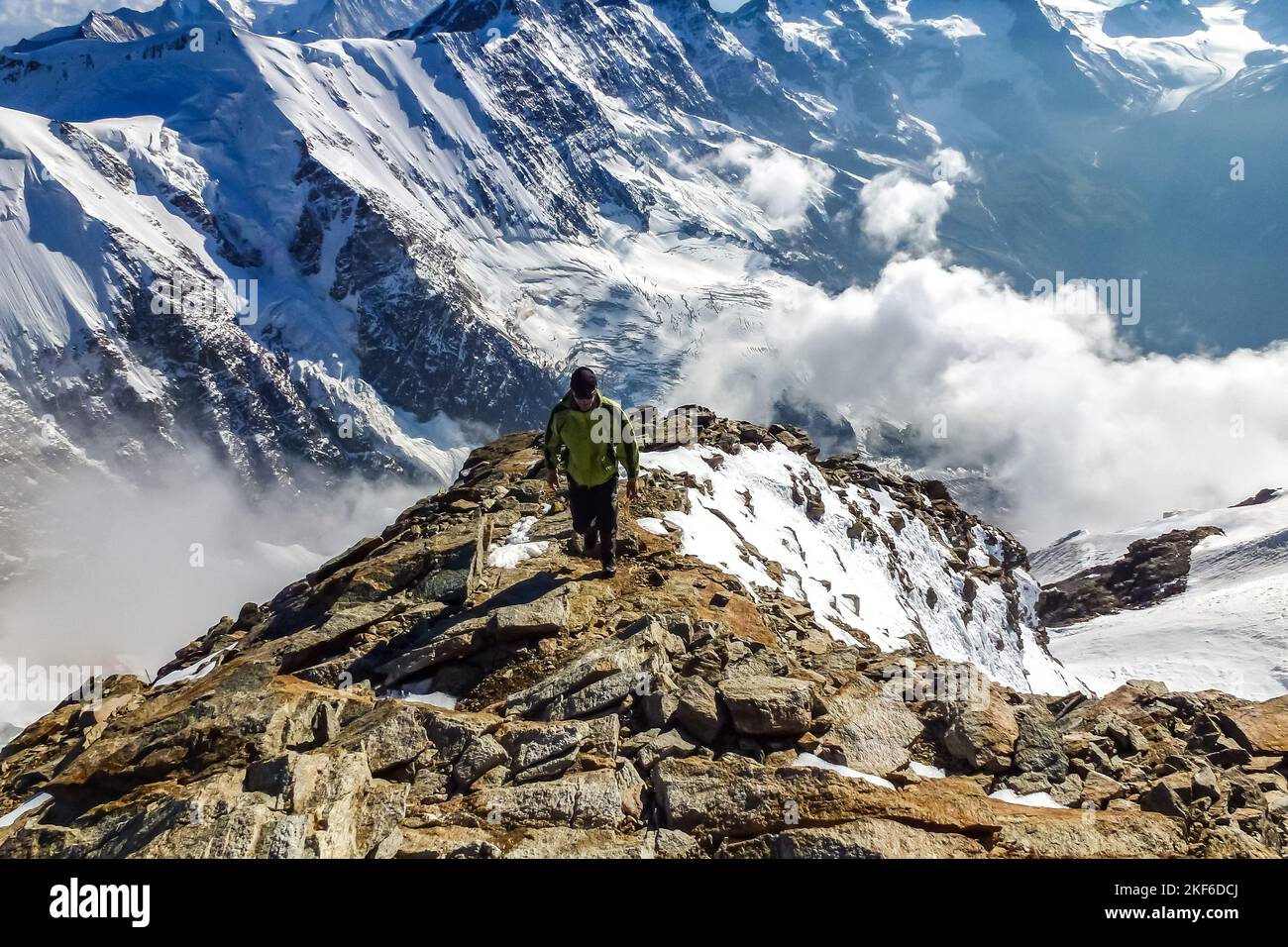 Description Enthusiastic mountaineer hiking on Jungfrau summit with