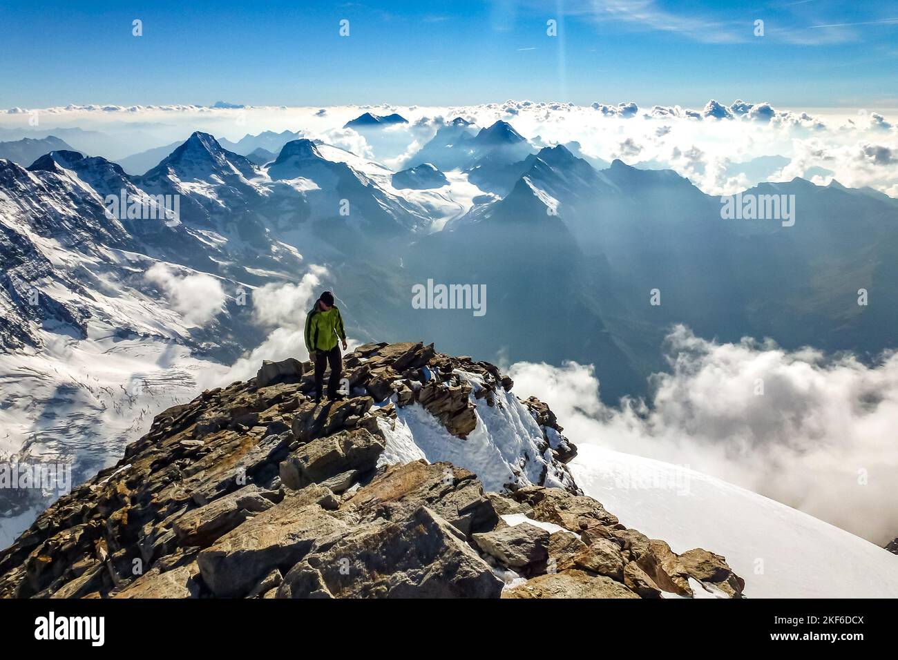Description Enthusiastic mountaineer hiking on Jungfrau summit with