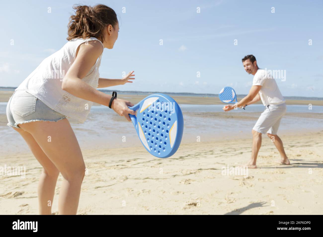 couple playing with bat and ball on the beach Stock Photo Alamy