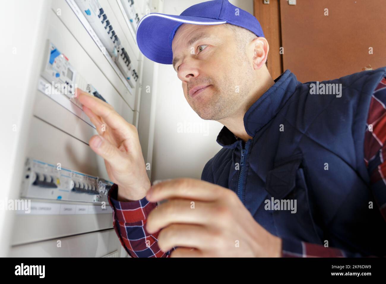 electrician installing energy saving meter Stock Photo
