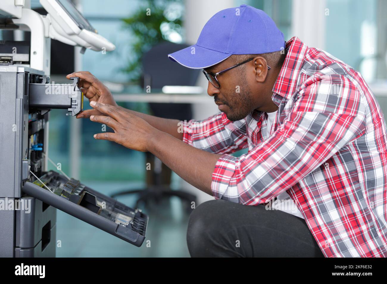a technician is checking a printer Stock Photo