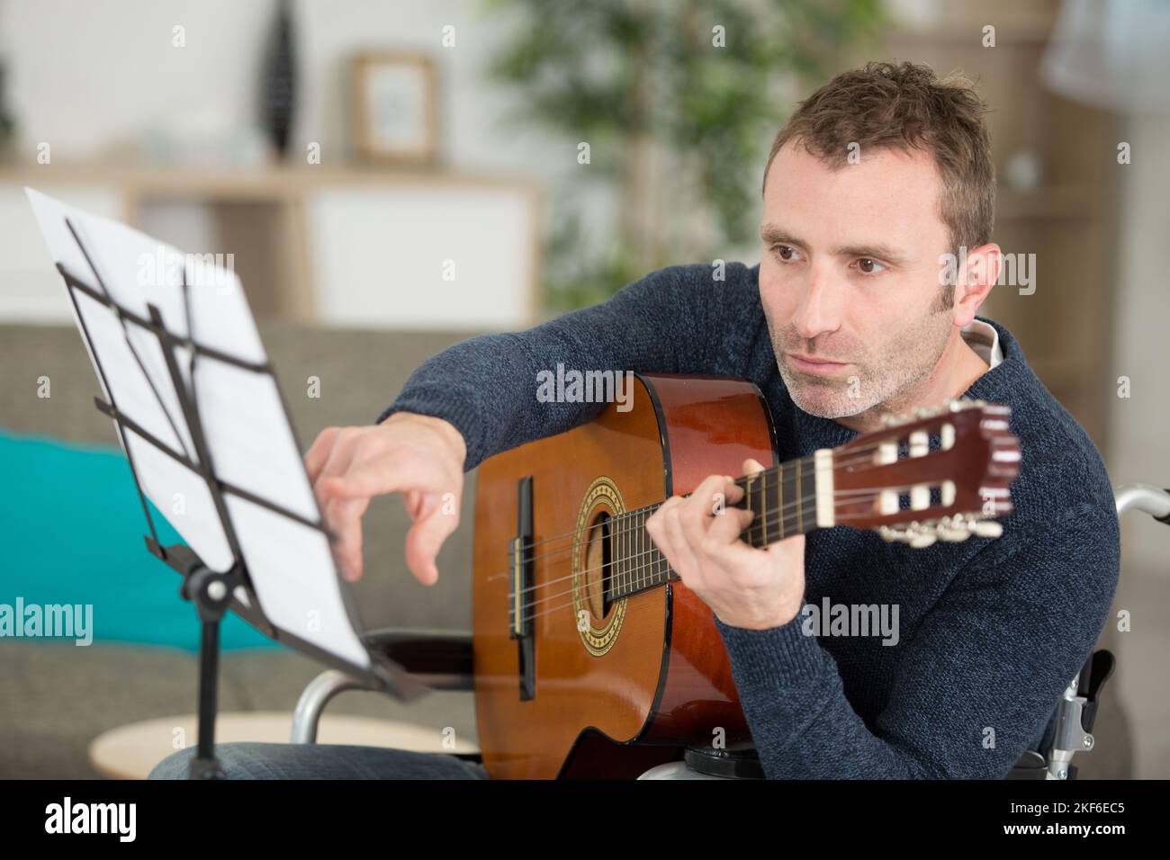 man holding guitar Stock Photo - Alamy