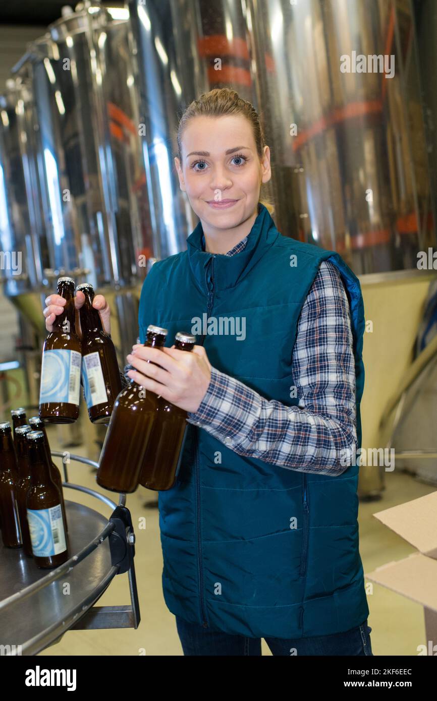 female brewery worker with bottling machinery on factory Stock Photo Alamy
