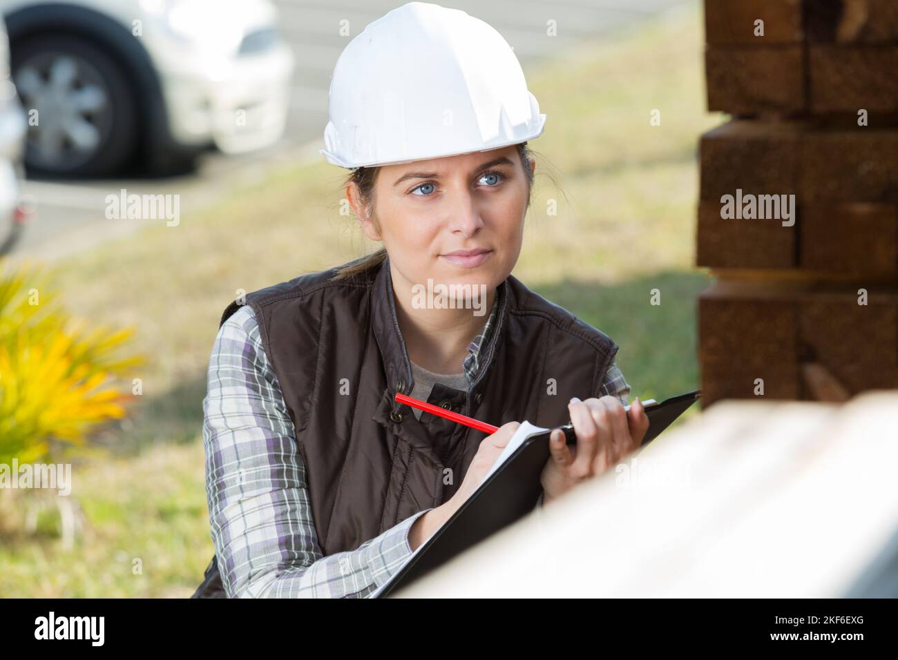 Woman Wearng Hardhat Making Notes On Clipboard Stock Photo Alamy Woman wearng hardhat making notes on clipboard stock photo alamy