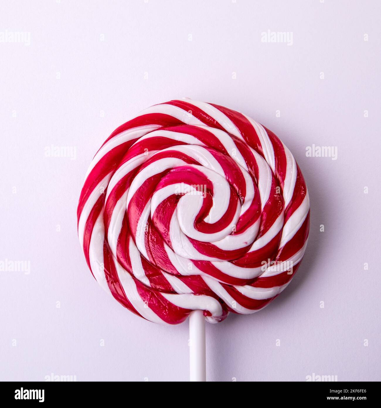 Red and white striped lollipop, candy on a stick Stock Photo Alamy