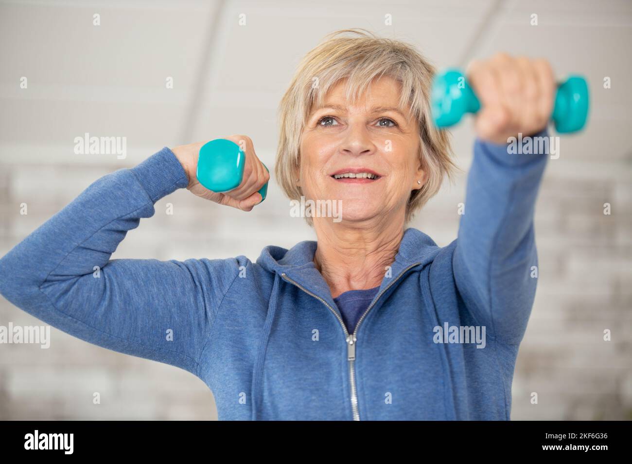 senior fitness woman training with dumbbells Stock Photo - Alamy