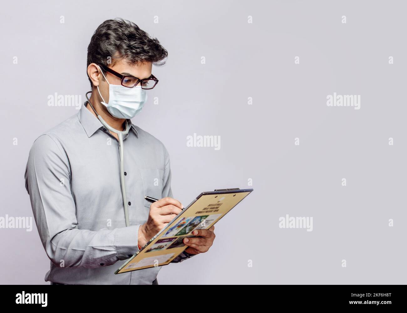 an-isolated-shot-of-a-south-asian-male-doctor-wearing-a-facemask-and