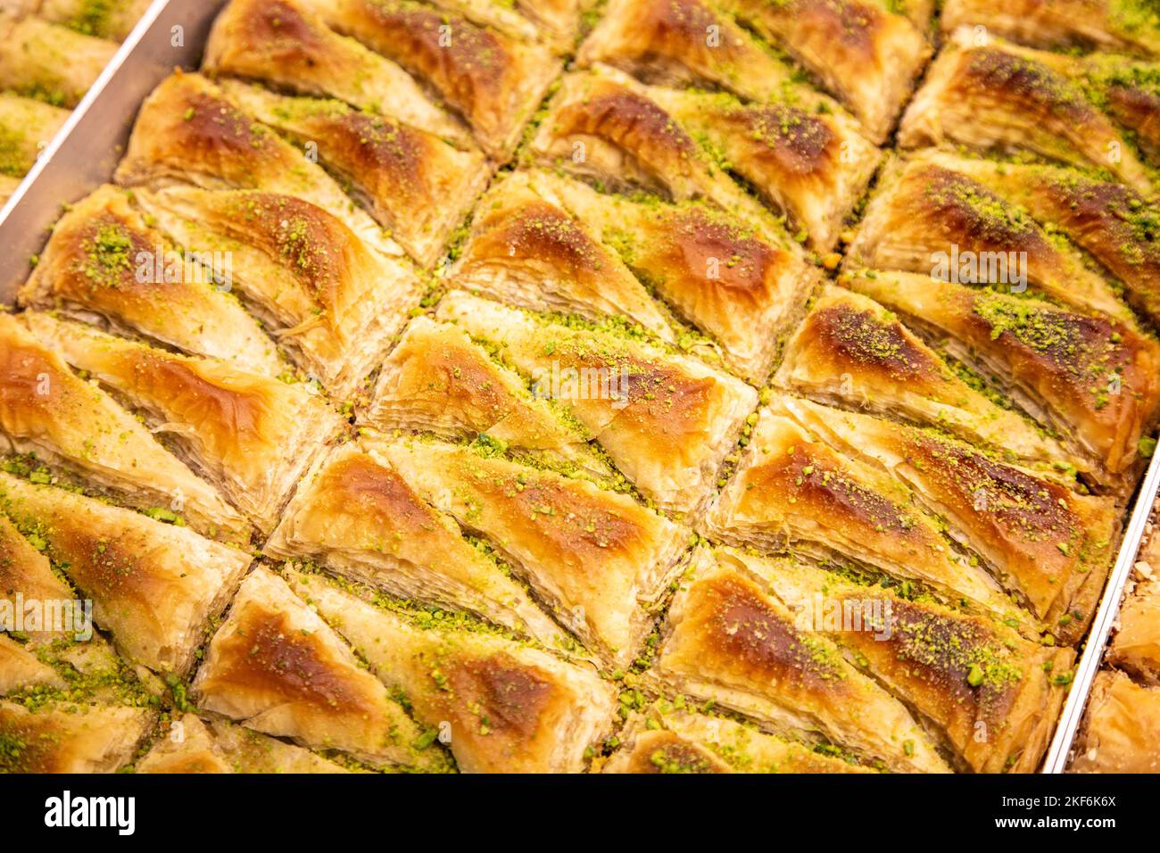 Tray of triangular Middle Eastern pistachio baklava pastries Stock Photo