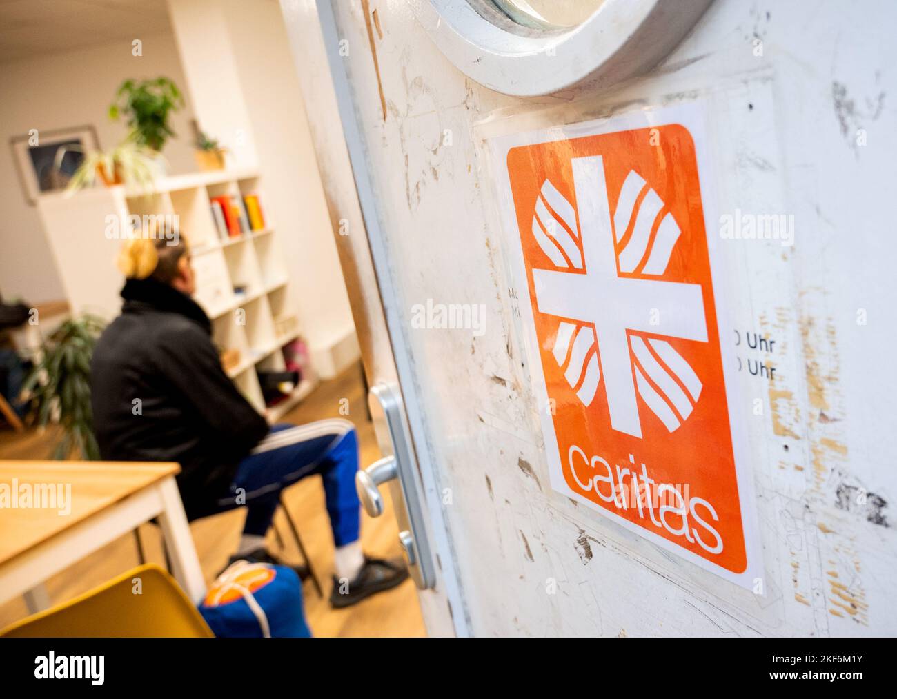 Hamburg, Germany. 16th Nov, 2022. A man sits in the 'Tagestreff CariCare' in the city center. Hamburg's Caritas has opened a new facility offering a wide range of services for the homeless. Credit: Daniel Bockwoldt/dpa/Alamy Live News Stock Photo