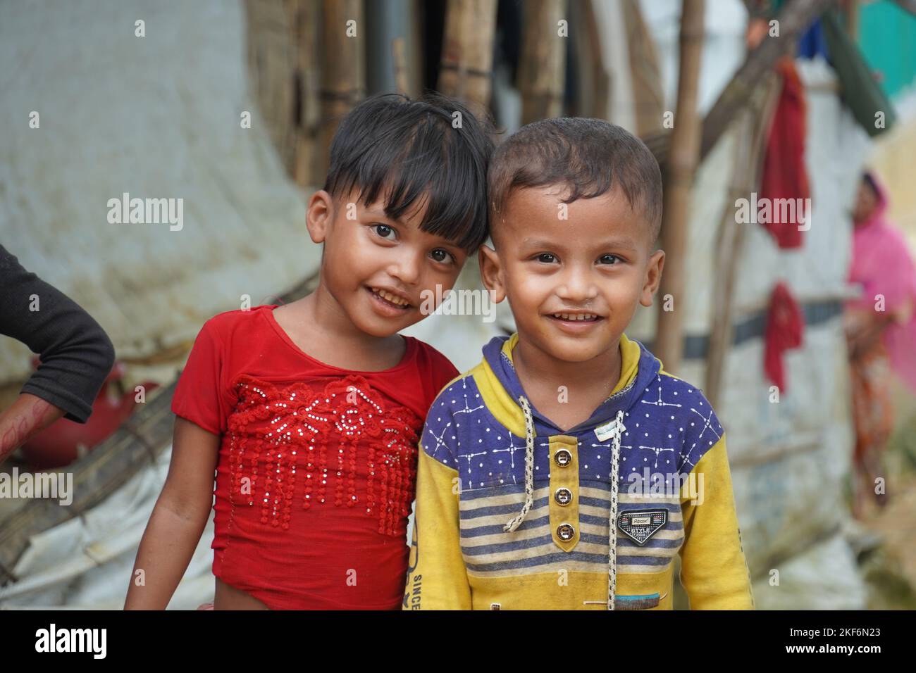 Two Rohingya kids pose smiling at the Rohingya Refugee camp in Cox's Bazar. More than a million Rohingya refugees live there. Stock Photo