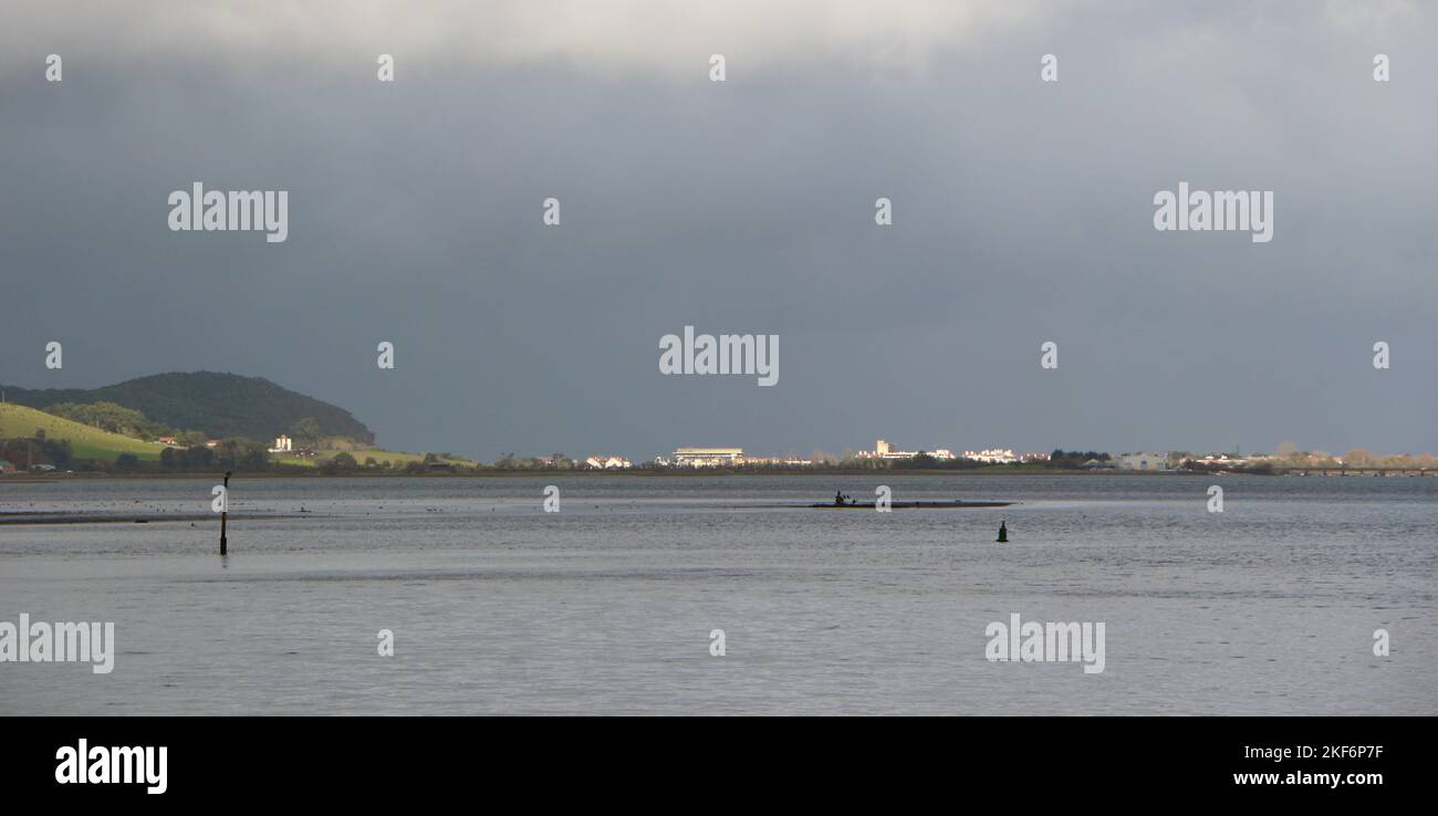 View across the shallows of the ría de Limpias towards Laredo on a cloudy morning Colindres Cantabria Spain Stock Photo
