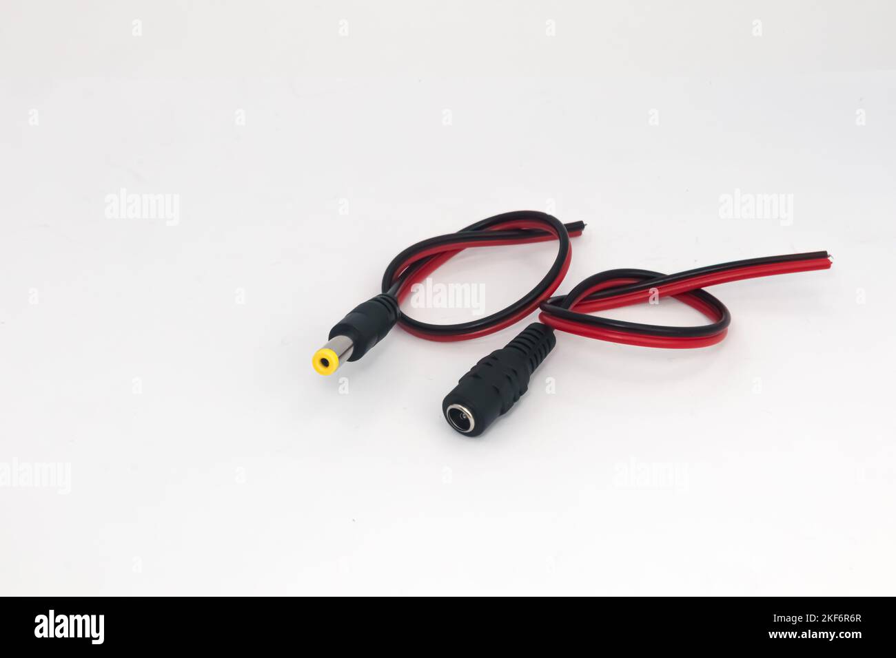 DC 12V male and female connector cables on a white background. Electronic parts used by hobbyists as battery connectors. Stock Photo