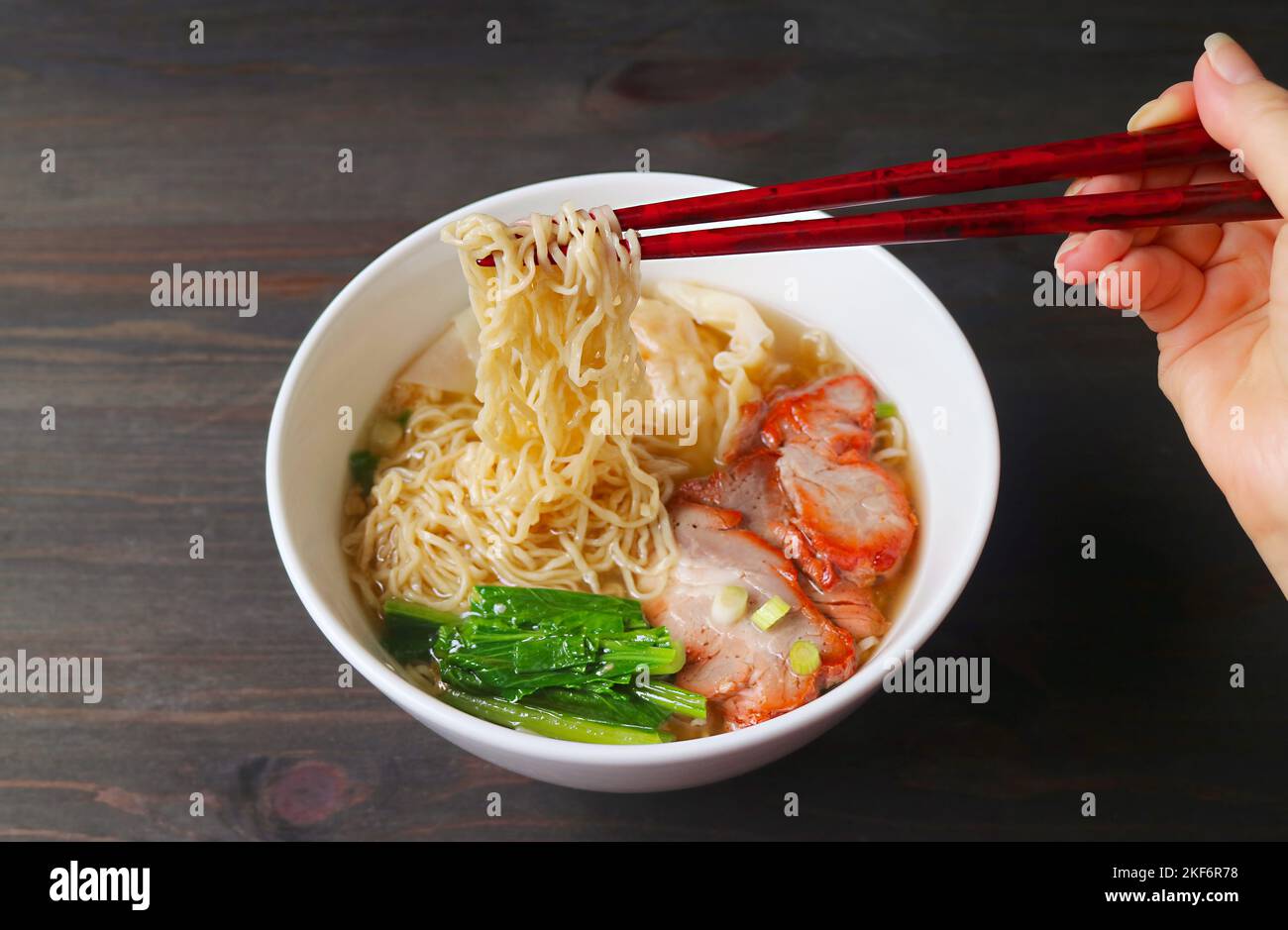 Hand Gripping Delectable Chinese Roasted Pork Egg Noodles with Chopsticks Stock Photo Alamy