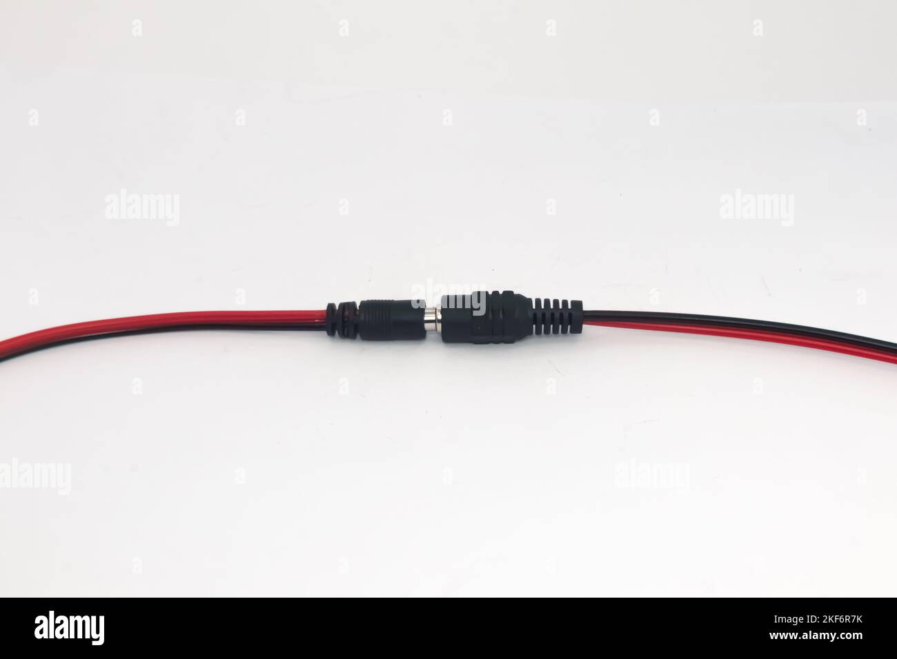 Connected DC 12V male and female connector cables isolated on white