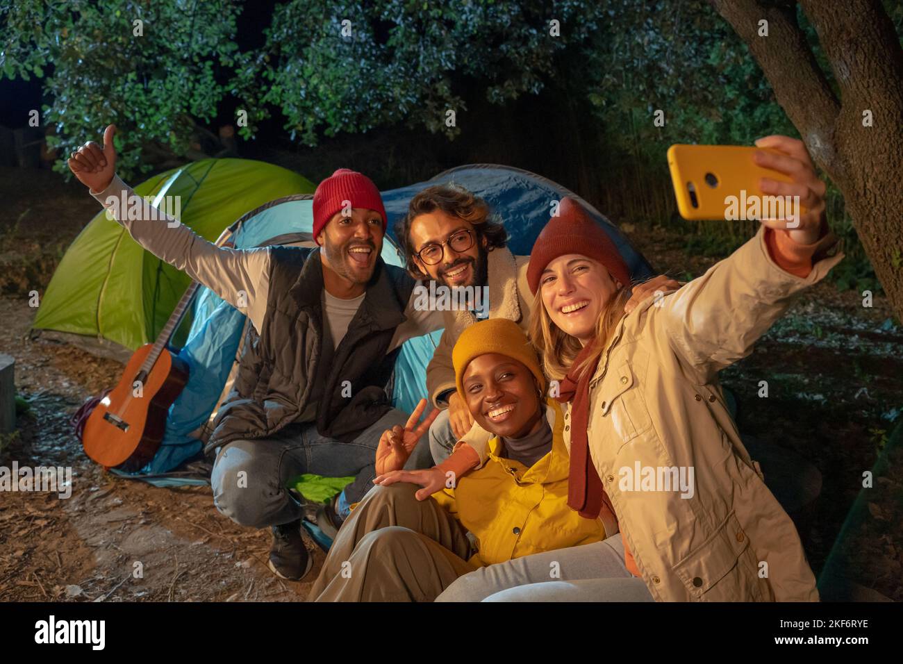 Happy multiracial friends taking selfie having fun together camping at ...