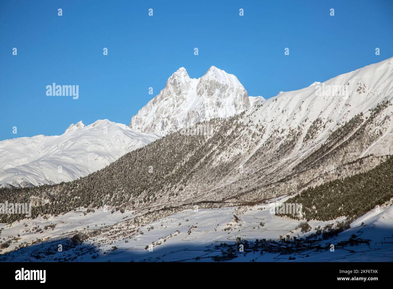 The slope of Mount Ushba is covered with snow and glaciers, Caucasus