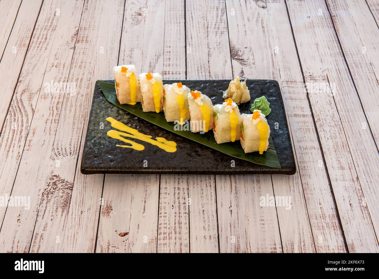 Tray of uramaki california roll with masago roe stuffed with avocado ...