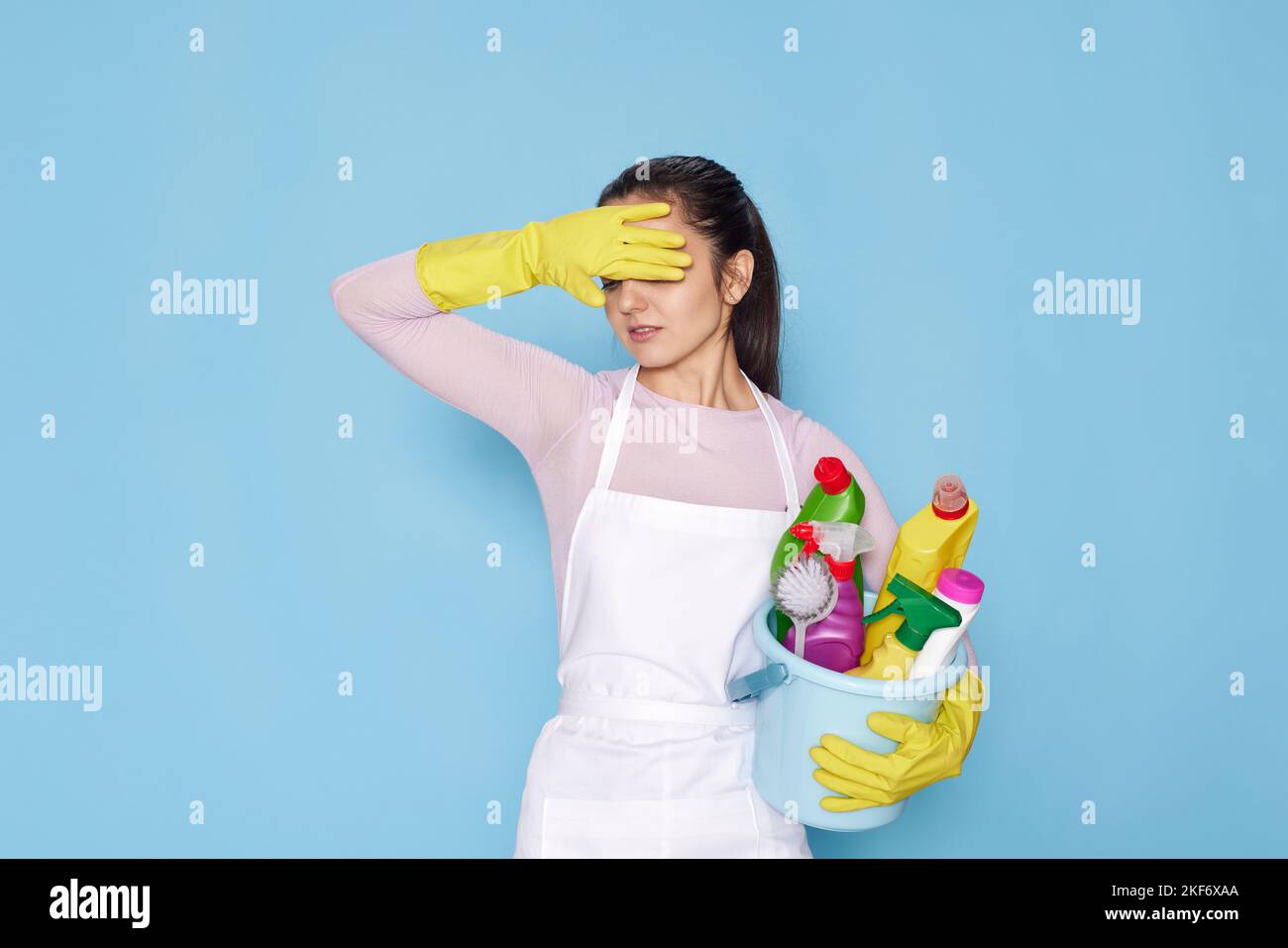 woman in gloves holding bucket with cleaning supplies and broom Stock ...