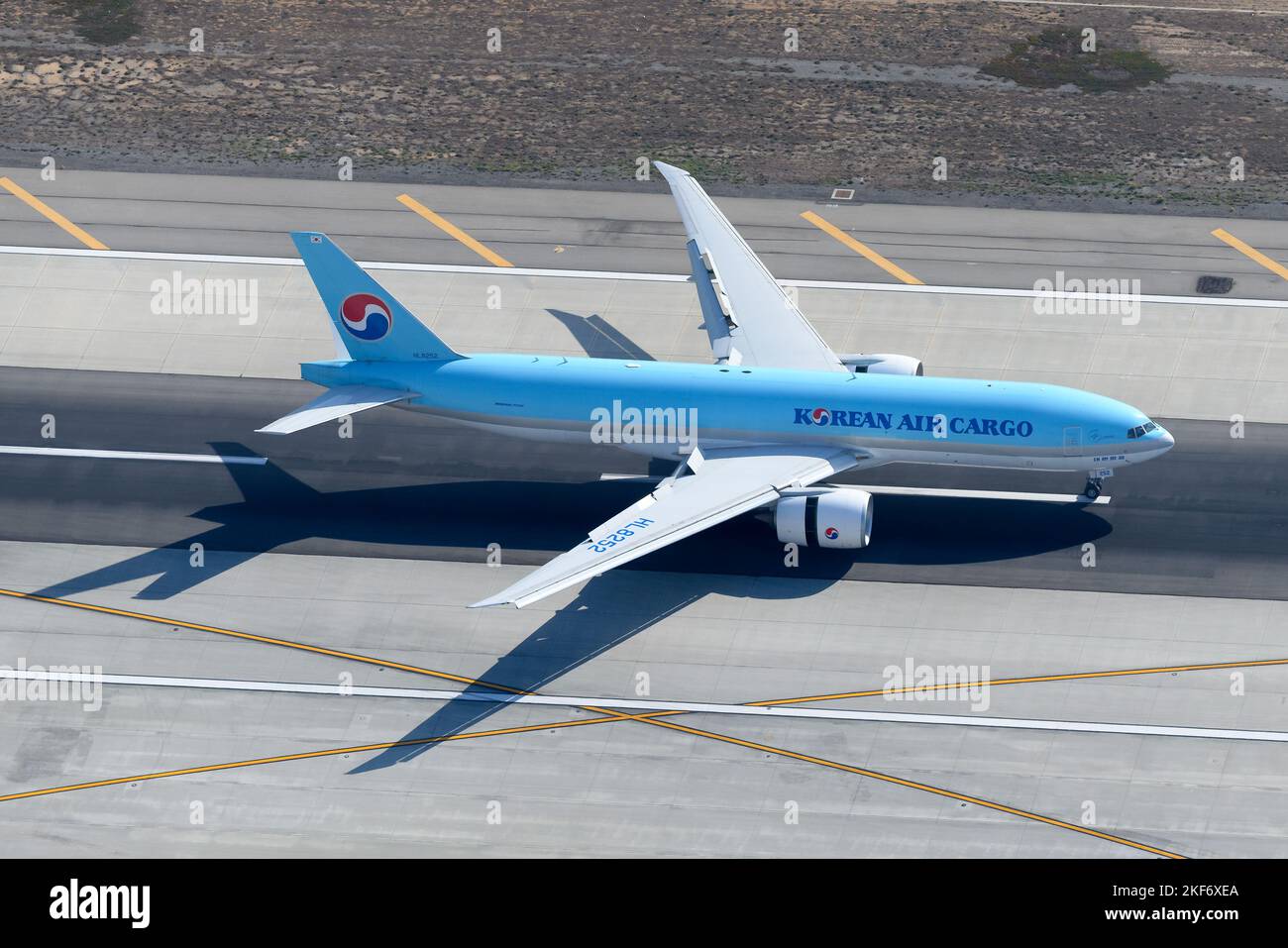 Korean Air Cargo Boeing 777 airplane landing. Plane 777 cargo on runway. Freighter aircraft of KoreanAir Cargo HL8252. Stock Photo