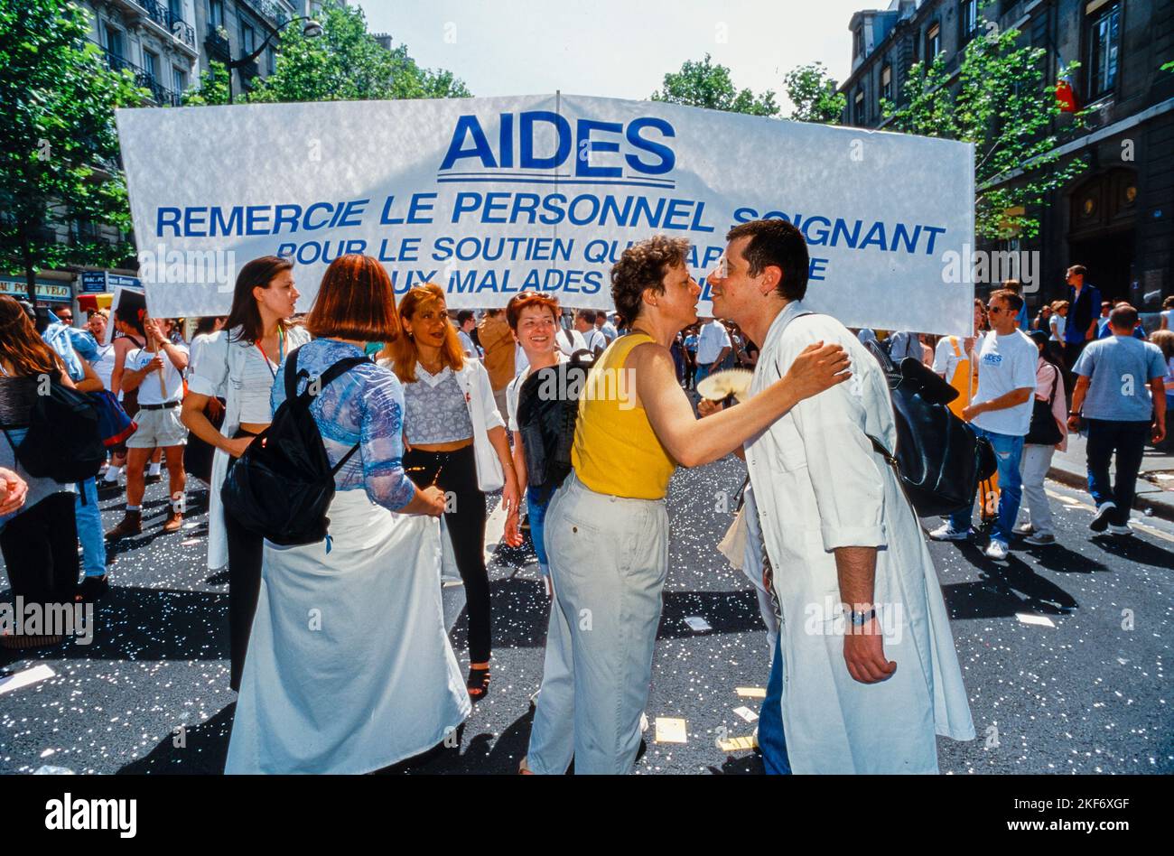 Paris, France, Large Crowd People, Marching in Gay Pride, LGBTQI+, AIDES NGO With Banner in Support of Health Care Workers, aids 1990s, logo, greeting, Kissing, epidemic and plague france Stock Photo