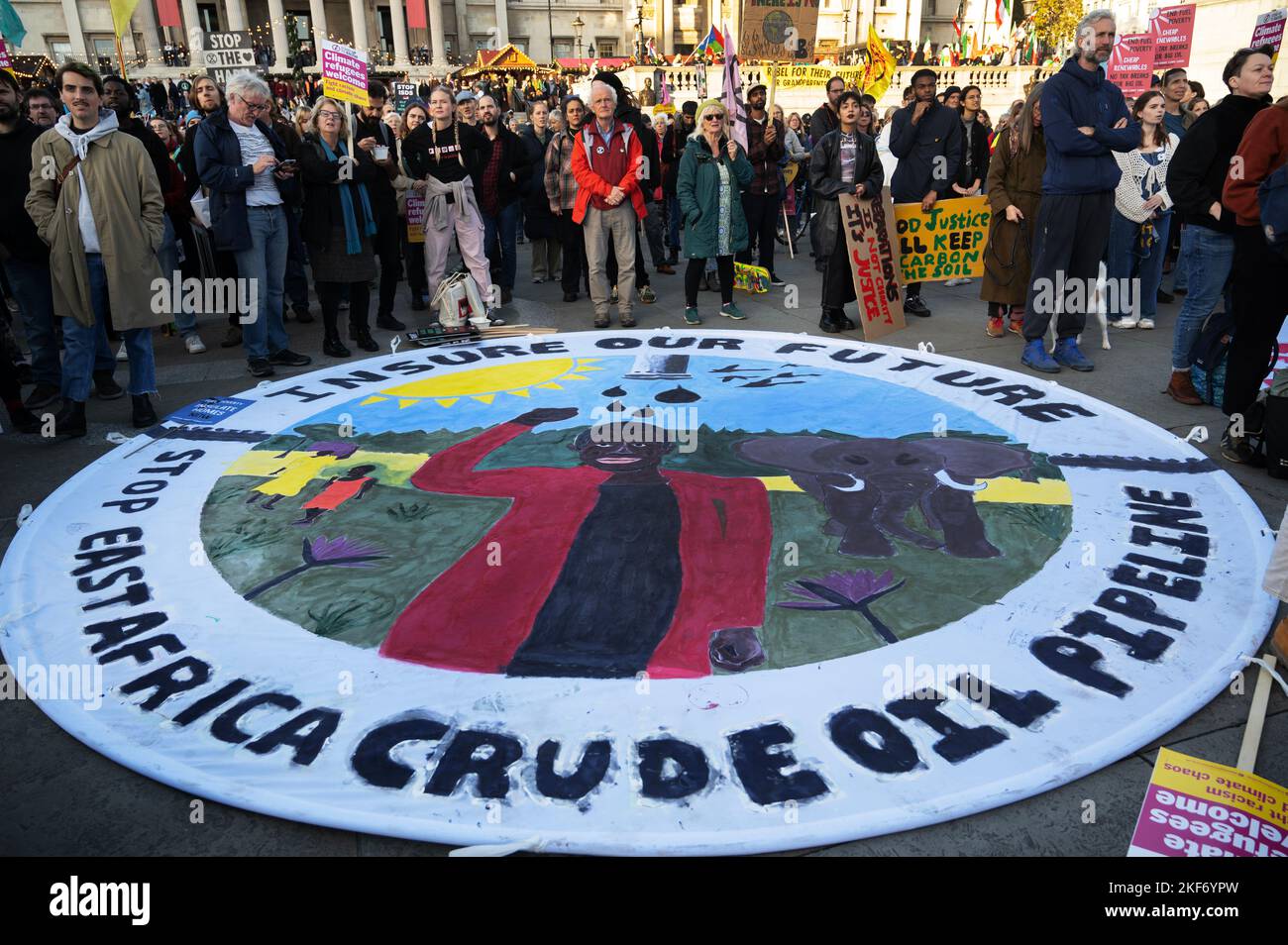 On November 12th 2022 protesters demonstrate for climate justice in Central London as the COP 27 talks finish in Egypt., with a large round banner cal Stock Photo