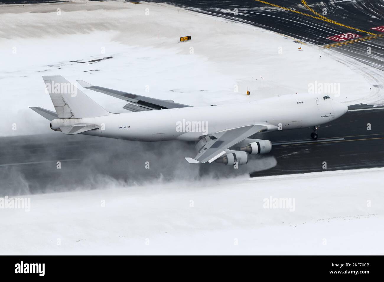 Boeing 747 cargo aircraft landing at Anchorage Airport after a heavy snow fall. Airplane 747-400F of Atlas Air with engines reverse thrust open. Stock Photo