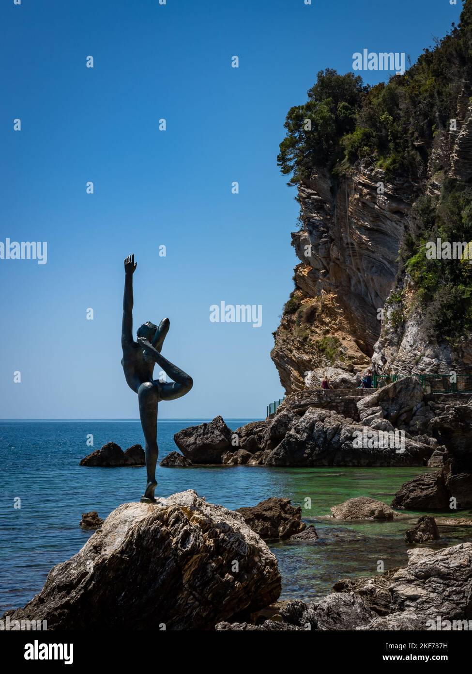 Budva, Montenegro - April 28, 2022: A dancing girl (Statua Ballerina)  bronze sculpture on the rocky coast of Adriatic sea. Stock Photo