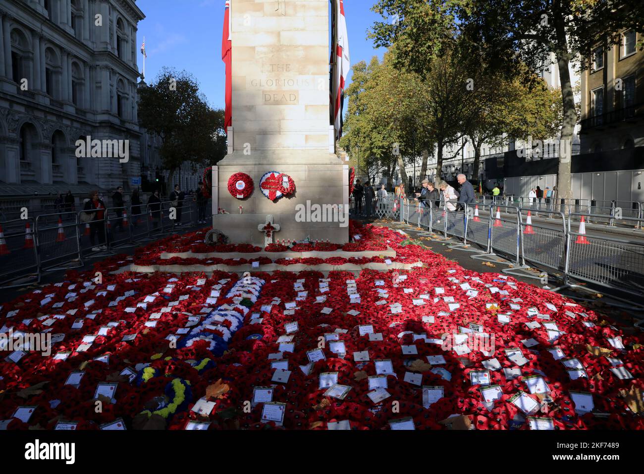 Wreaths laid at the Cenotaph memorial on Whitehall, London, UK on 16 November 2022, with members of the public looking on from the side. Stock Photo