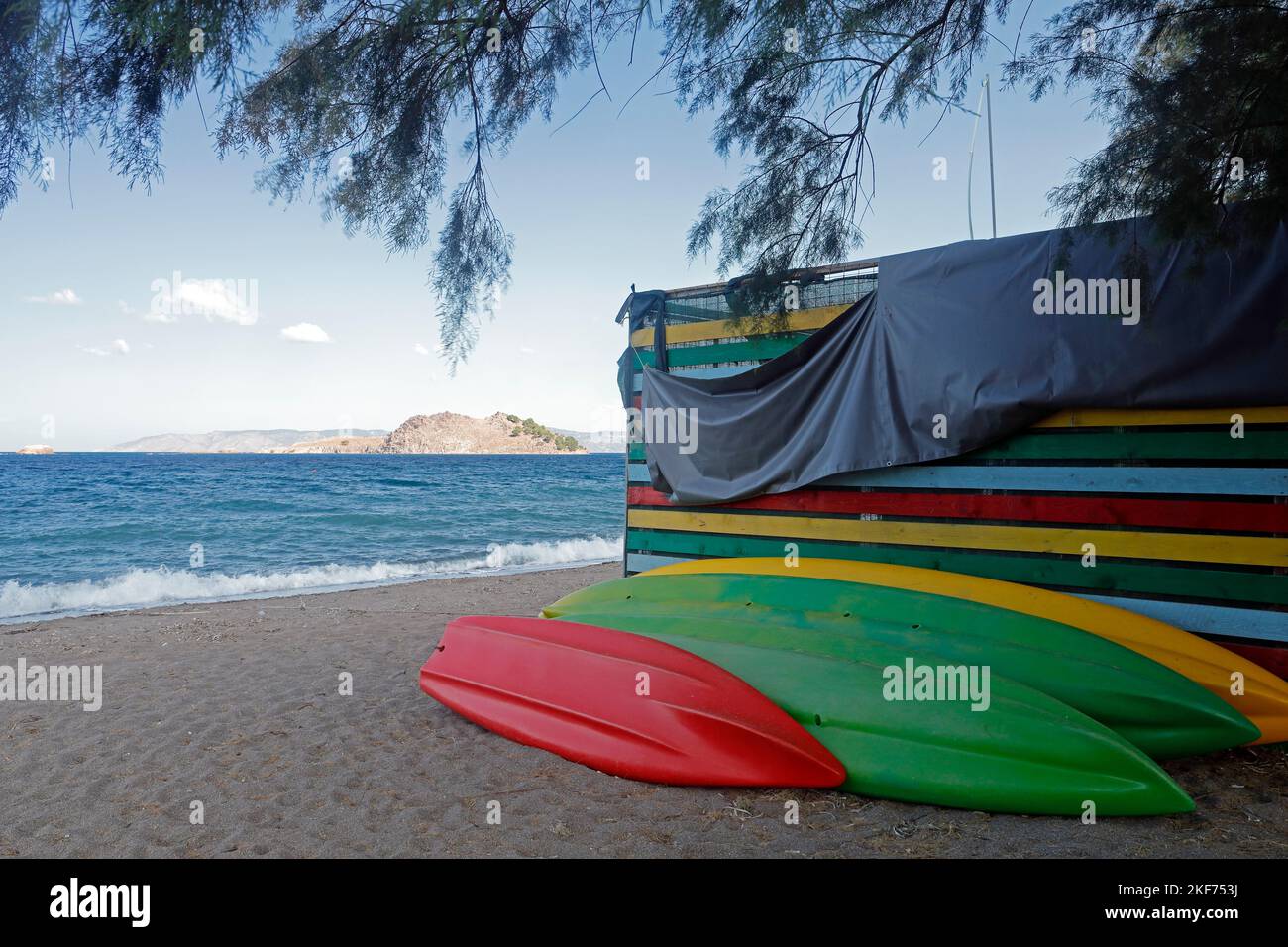 Colourful upside down kayaks / canoes. Anaxos beach October 2022. Autumn. cym Stock Photo