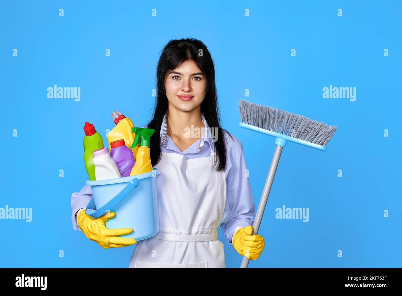 woman in gloves holding bucket of detergents and broom Stock Photo - Alamy