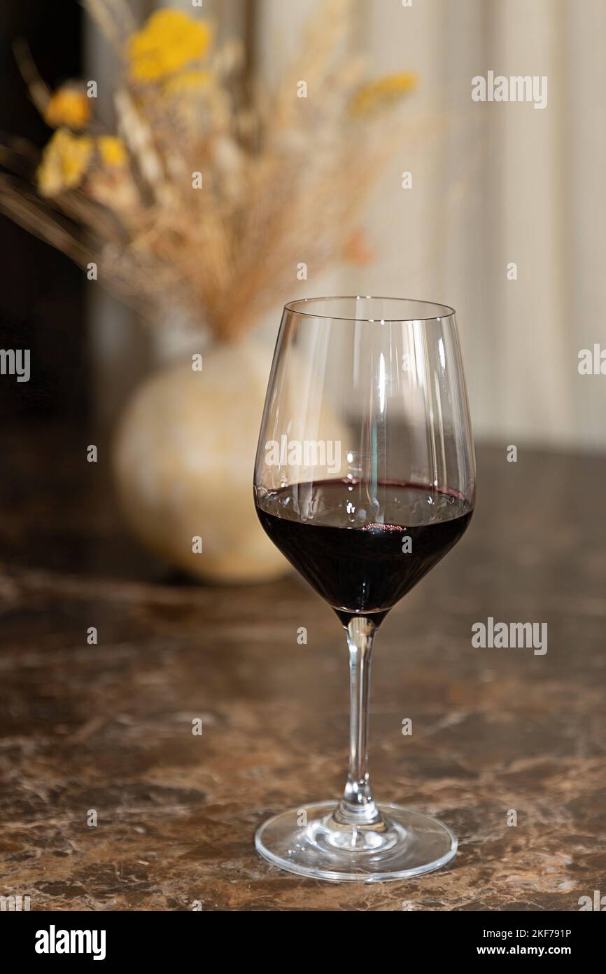 The glass of red, white wine on the table, in woman hand Stock Photo