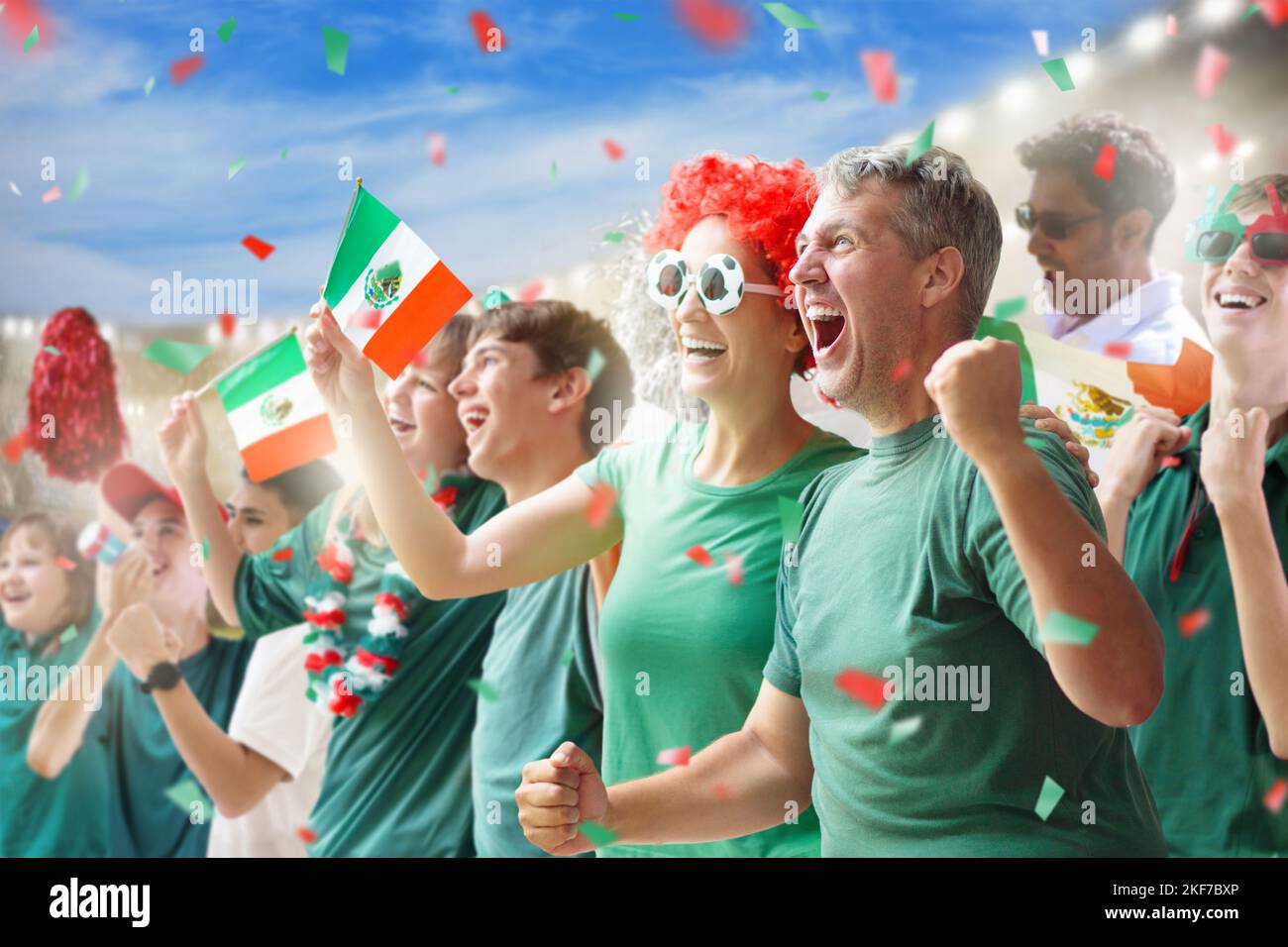 Mexico football supporter on stadium. Mexican fans on soccer pitch watching team play. Group of supporters with flag and national jersey Stock Photo