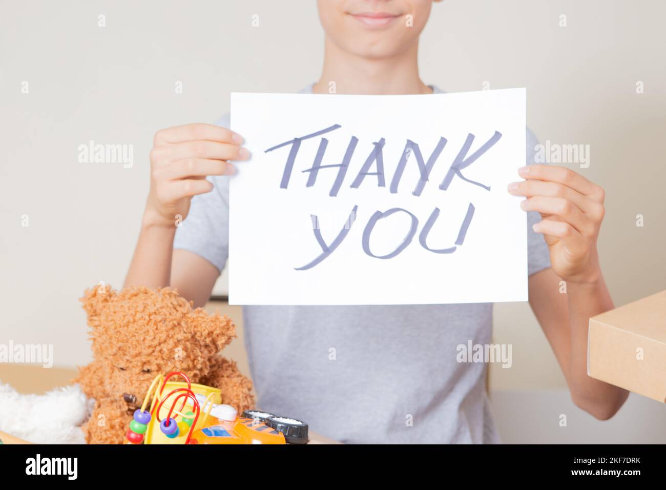 Thank you for donation. Volunteers collecting donations for charity. Teenage boy holding paper