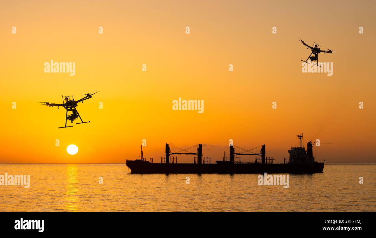 Drones flying over bulk cargo ship at sunrise. Ukraine grain, wheat, Russia, Russian war, food blockade, shipping, food prices attack.. concept Stock Photo