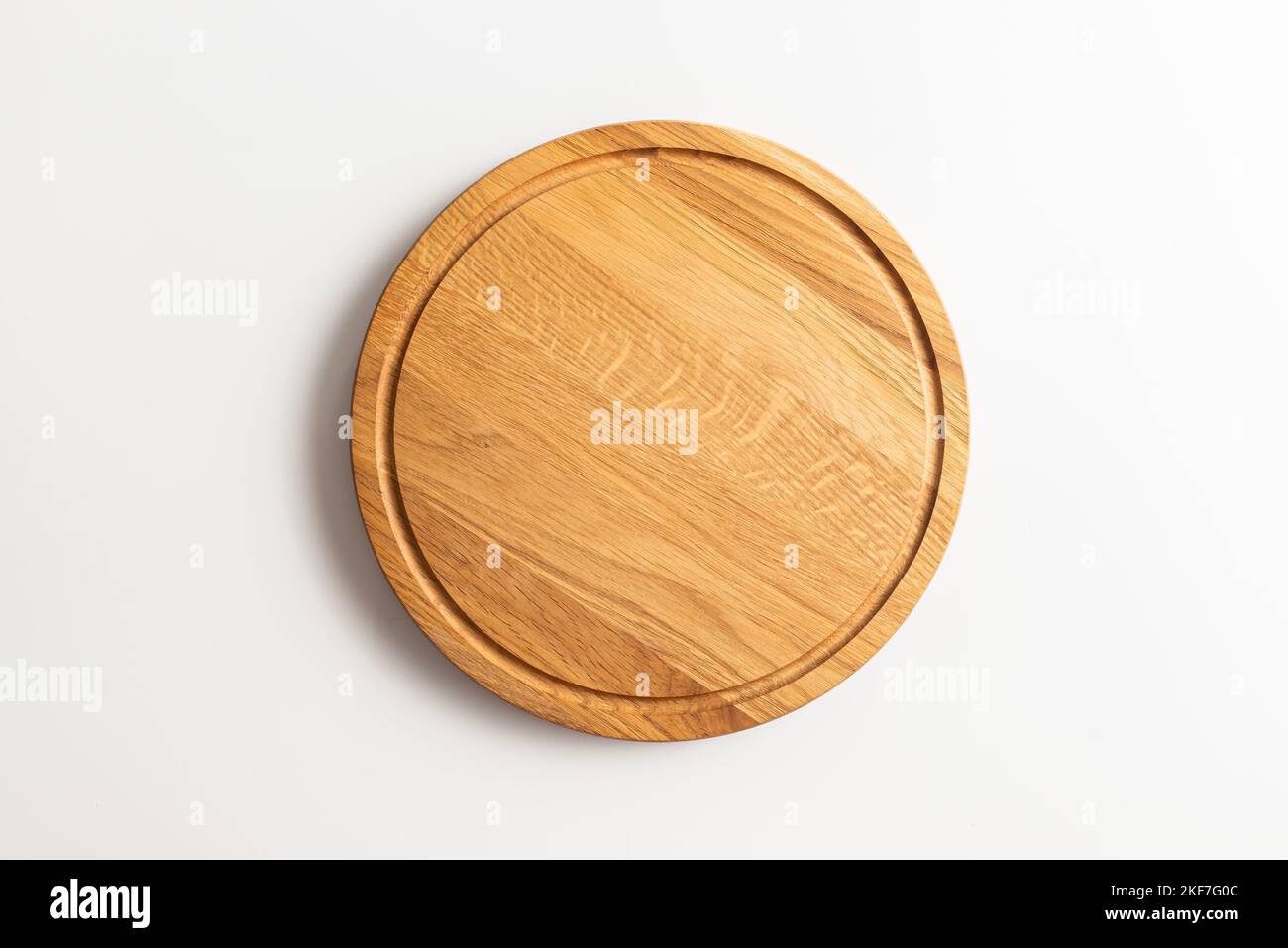 Empty wood round cutting board on white background Stock Photo