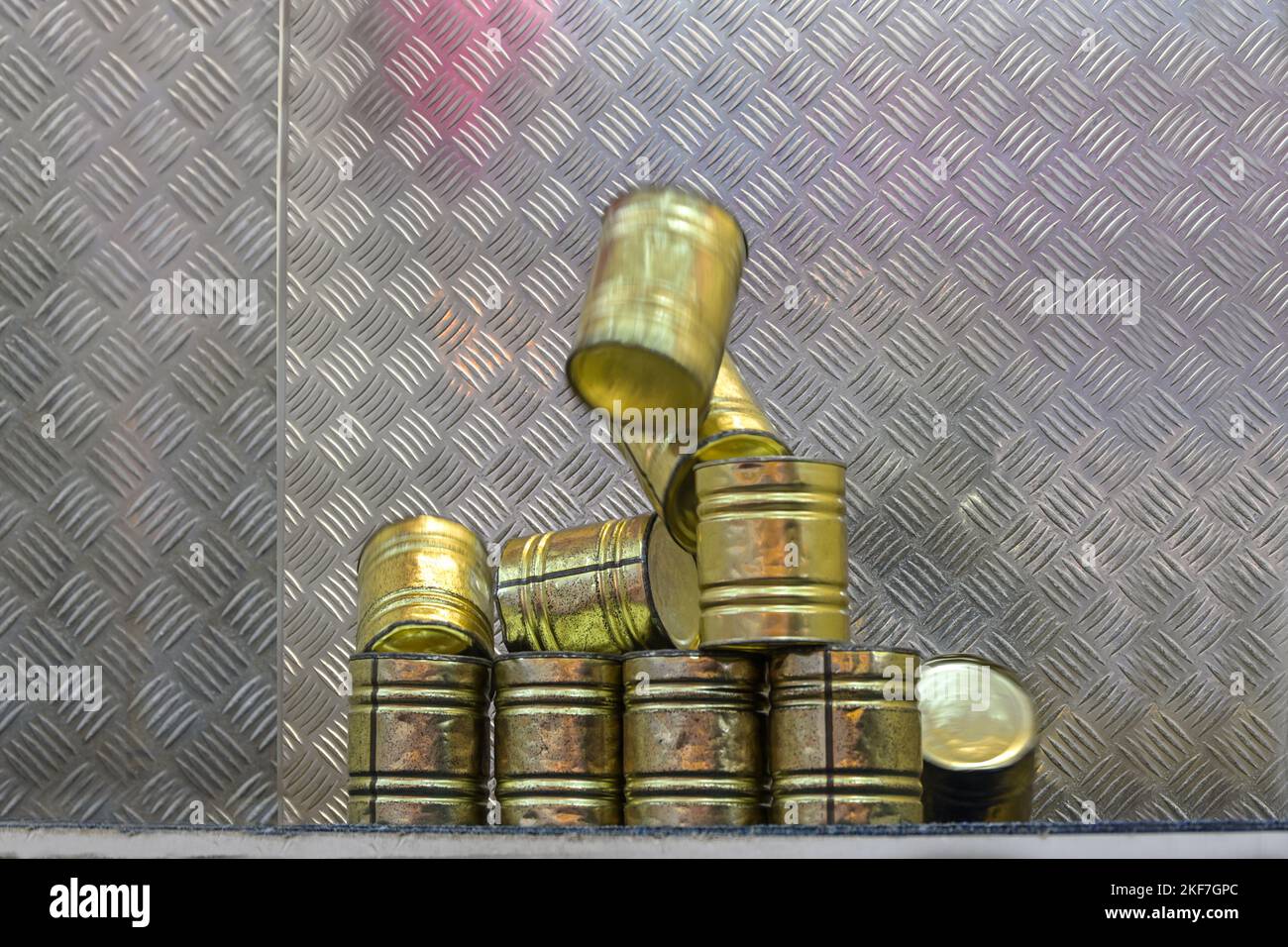 Falling tin can pyramid hit by a ball, throwing game at a carnival funfair or Christmas market, copy space, selected focus, motion blur Stock Photo